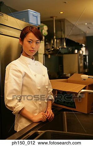 Portrait of a female chef standing near a kitchen sink View Large Photo Image Stock Image - Portrait of a female chef standing near a kitchen sink. Fotosearch