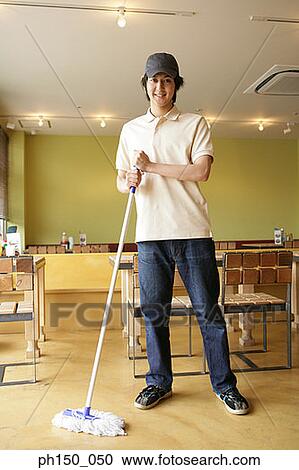 Portrait of a waiter cleaning the floor in a restaurant and smiling View Large Photo Image Stock Image - Portrait of a waiter cleaning the floor in a restaurant and smiling. Fotosearch
