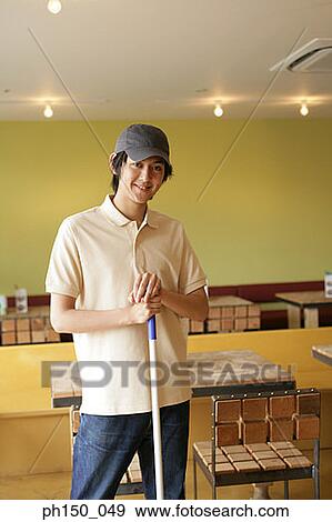 Portrait of a waiter holding a mop and smiling View Large Photo Image Stock Photo - Portrait of a waiter holding a mop and smiling. Fotosearch