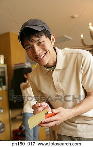 Portrait of a waiter holding a notepad and a pen View Large Photo Image Stock Photo - Portrait of a waiter holding a notepad and a pen. Fotosearch