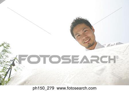 Portrait of a waiter holding a tablecloth and smiling View Large Photo Image Stock Photo - Portrait of a waiter holding a tablecloth and smiling. Fotosearch
