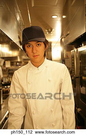 Portrait of a waiter standing in the kitchen View Large Photo Image Stock Image - Portrait of a waiter standing in the kitchen. Fotosearch