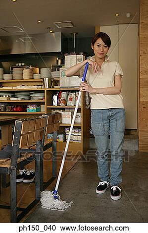 Portrait of a waitress holding a mop and smiling View Large Photo Image Stock Image - Portrait of a waitress holding a mop and smiling. Fotosearch