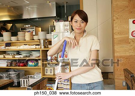 Portrait of a waitress holding a mop and smiling View Large Photo Image Stock Photo - Portrait of a waitress holding a mop and smiling. Fotosearch