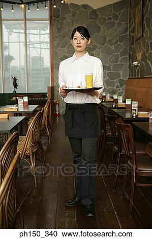 Portrait of a waitress holding a serving tray View Large Photo Image Stock Image - Portrait of a waitress holding a serving tray. Fotosearch