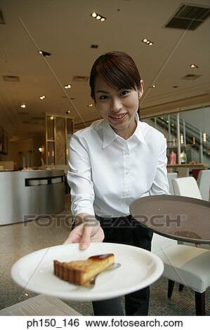 Portrait of a waitress holding a tray and smiling View Large Photo Image Stock Photograph - Portrait of a waitress holding a tray and smiling. Fotosearch