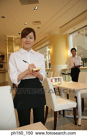 Portrait of a waitress taking an order with a waiter standing in the background View Large Photo Image Stock Image - Portrait of a waitress taking an order with a waiter standing in the background. Fotosearch