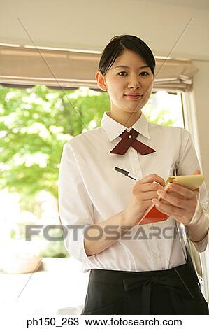 Portrait of a waitress writing on a notepad View Large Photo Image Stock Image - Portrait of a waitress writing on a notepad. Fotosearch