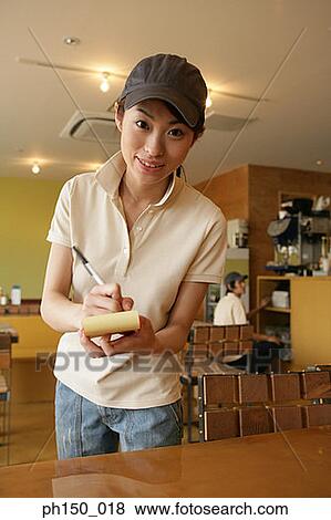 Portrait of a waitress writing on a notepad and smiling View Large Photo Image Stock Photo - Portrait of a waitress writing on a notepad and smiling. Fotosearch