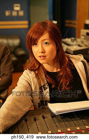 Portrait of a young woman at a mixing desk View Large Photo Image Stock Photo - Portrait of a young woman at a mixing desk. Fotosearch
