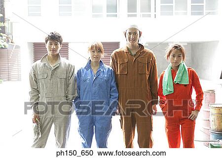 Stock Image - Portrait of four auto mechanics standing in an auto repair shop. Fotosearch