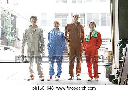 Stock Photo - Portrait of four auto mechanics standing in an auto repair shop. Fotosearch