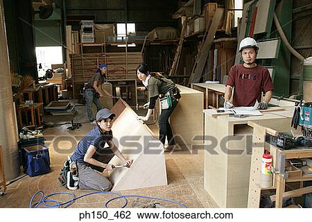 Portrait of four carpenters working in a workshop View Large Photo Image Stock Image - Portrait of four carpenters working in a workshop. Fotosearch