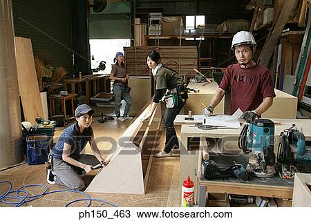 Portrait of four carpenters working in a workshop View Large Photo Image Stock Image - Portrait of four carpenters working in a workshop. Fotosearch