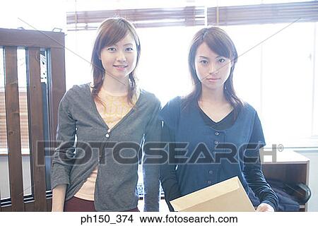 Picture - Portrait of two businesswomen smiling. Fotosearch