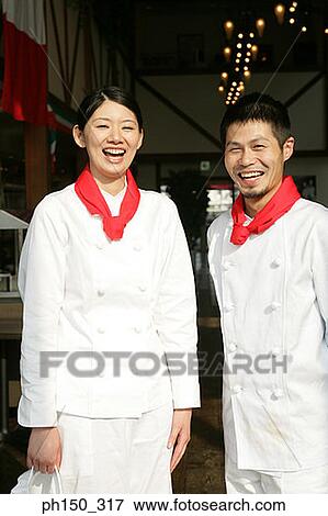 Portrait of two chefs standing in a restaurant and smiling View Large Photo Image Stock Photo - Portrait of two chefs standing in a restaurant and smiling. Fotosearch