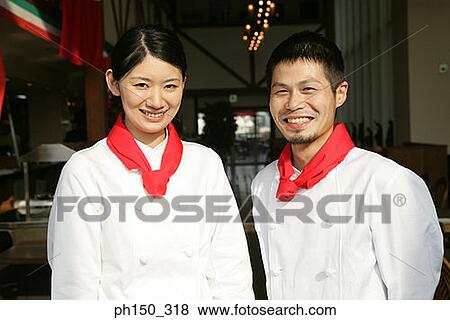 Portrait of two chefs standing in a restaurant and smiling View Large Photo Image Stock Photo - Portrait of two chefs standing in a restaurant and smiling. Fotosearch