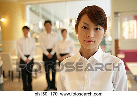 Portrait of two waiters and two waitresses standing in a restaurant View Large Photo Image Stock Image - Portrait of two waiters and two waitresses standing in a restaurant. Fotosearch