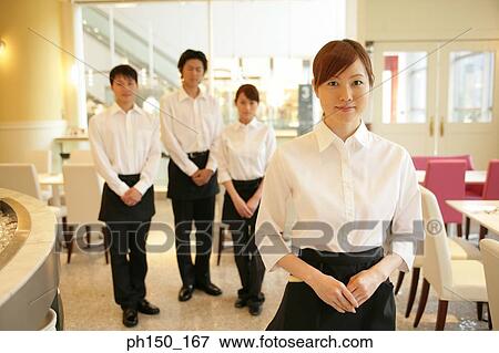 Portrait of two waiters and two waitresses standing in a restaurant View Large Photo Image Stock Photo - Portrait of two waiters and two waitresses standing in a restaurant. Fotosearch