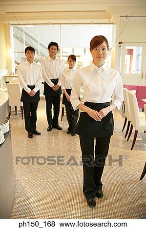 Portrait of two waiters and two waitresses standing in a restaurant View Large Photo Image Stock Photo - Portrait of two waiters and two waitresses standing in a restaurant. Fotosearch