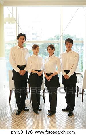 Portrait of two waiters and two waitresses standing in a restaurant View Large Photo Image Stock Photograph - Portrait of two waiters and two waitresses standing in a restaurant. Fotosearch