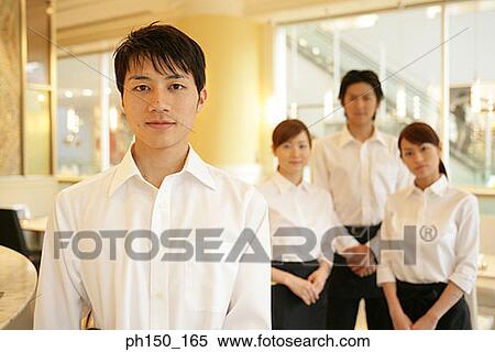 Portrait of two waiters and two waitresses standing in a restaurant View Large Photo Image Stock Photography - Portrait of two waiters and two waitresses standing in a restaurant. Fotosearch