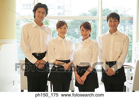Stock Photography - Portrait of two waiters and two waitresses standing in a restaurant. Fotosearch