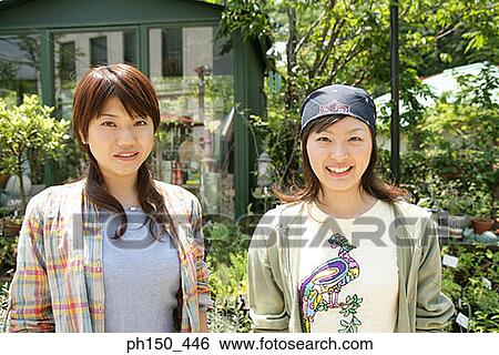 Portrait of two young women smiling View Large Photo Image Stock Photograph - Portrait of two young women smiling. Fotosearch