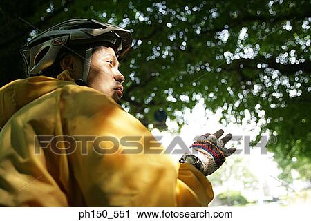 Stock Image - Rear view of a young man looking away. Fotosearch