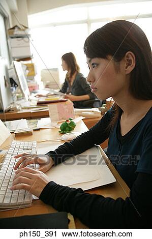 Side profile of a businesswoman working on a computer View Large Photo Image Stock Image - Side profile of a businesswoman working on a computer. Fotosearch