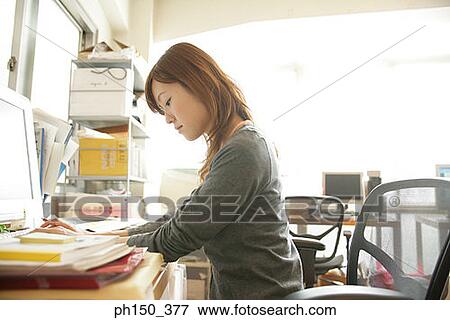 Side profile of a businesswoman working on a computer View Large Photo Image Stock Photo - Side profile of a businesswoman working on a computer. Fotosearch