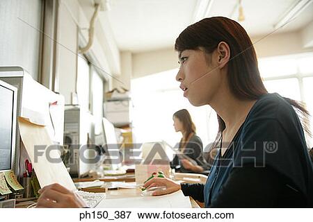 Side profile of a businesswoman working on a computer View Large Photo Image Stock Photo - Side profile of a businesswoman working on a computer. Fotosearch