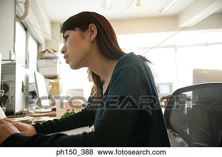 Side profile of a businesswoman working on a computer View Large Photo Image Stock Photo - Side profile of a businesswoman working on a computer. Fotosearch