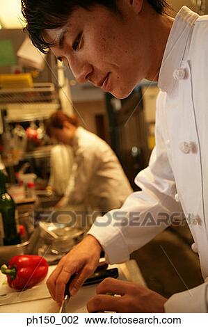 Side profile of a chef holding a knife in the kitchen View Large Photo Image Stock Image - Side profile of a chef holding a knife in the kitchen. Fotosearch