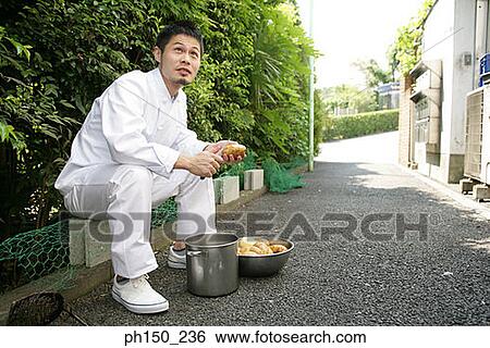 Side profile of a chef peeling raw potatoes on the street View Large Photo Image Stock Photograph - Side profile of a chef peeling raw potatoes on the street. Fotosearch