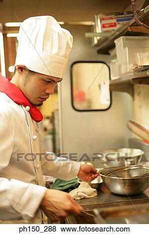 Side profile of a chef preparing food in the kitchen View Large Photo Image Stock Photo - Side profile of a chef preparing food in the kitchen. Fotosearch