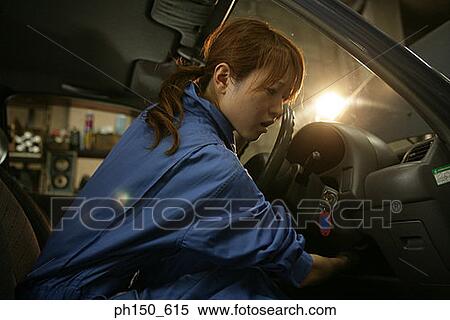 Side profile of a female auto mechanic examining a car View Large Photo Image Stock Photography - Side profile of a female auto mechanic examining a car. Fotosearch