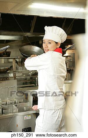 Side profile of a female chef preparing food in the kitchen View Large Photo Image Stock Image - Side profile of a female chef preparing food in the kitchen. Fotosearch