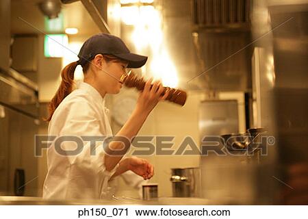 Side profile of a female chef shaking a pepper mill View Large Photo Image Stock Image - Side profile of a female chef shaking a pepper mill. Fotosearch