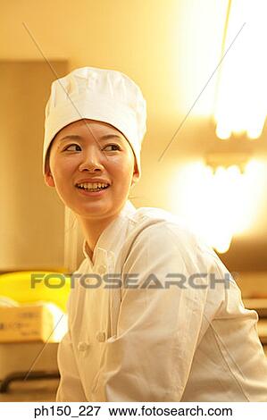 Side profile of a female chef smiling View Large Photo Image Stock Photo - Side profile of a female chef smiling. Fotosearch