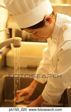 Side profile of a female chef washing utensils View Large Photo Image Stock Photography - Side profile of a female chef washing utensils. Fotosearch