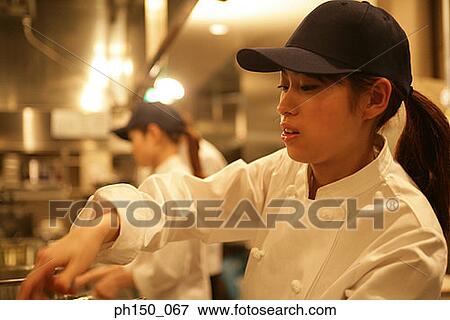 Side profile of a female chef working View Large Photo Image Stock Photo - Side profile of a female chef working. Fotosearch