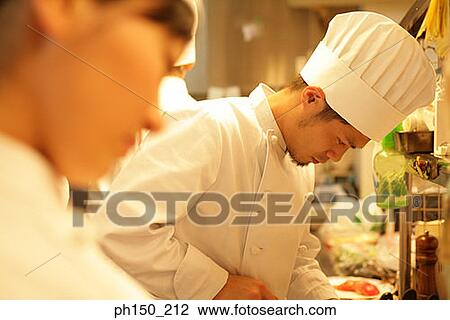 Side profile of a male chef and his colleagues in the kitchen View Large Photo Image Stock Image - Side profile of a male chef and his colleagues in the kitchen. Fotosearch