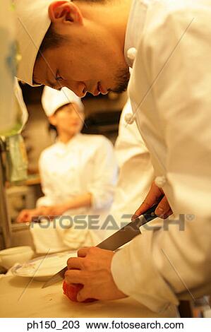 Side profile of a male chef cutting a tomato View Large Photo Image Stock Image - Side profile of a male chef cutting a tomato. Fotosearch