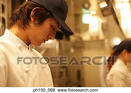Side profile of a male chef looking down View Large Photo Image Stock Photo - Side profile of a male chef looking down. Fotosearch