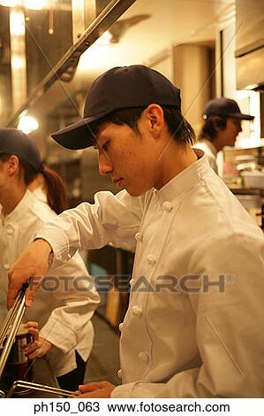 Side profile of a male chef preparing food with his colleagues View Large Photo Image Stock Image - Side profile of a male chef preparing food with his colleagues. Fotosearch