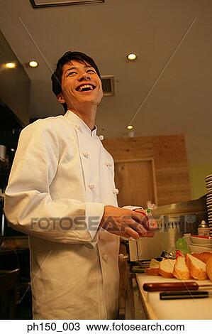 Side profile of a male chef standing at a kitchen counter and laughing View Large Photo Image Stock Image - Side profile of a male chef standing at a kitchen counter and laughing. Fotosearch