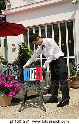 Side profile of a waiter holding an open placard View Large Photo Image Stock Image - Side profile of a waiter holding an open placard. Fotosearch