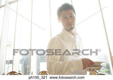 Side profile of a waiter holding plates View Large Photo Image Stock Image - Side profile of a waiter holding plates. Fotosearch