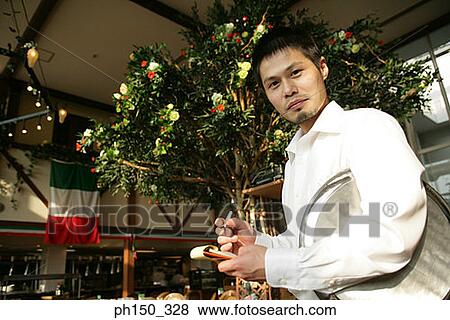 Side profile of a waiter taking an order in a restaurant View Large Photo Image Stock Photo - Side profile of a waiter taking an order in a restaurant. Fotosearch